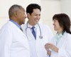 Three Doctors Standing Outside A Hospital